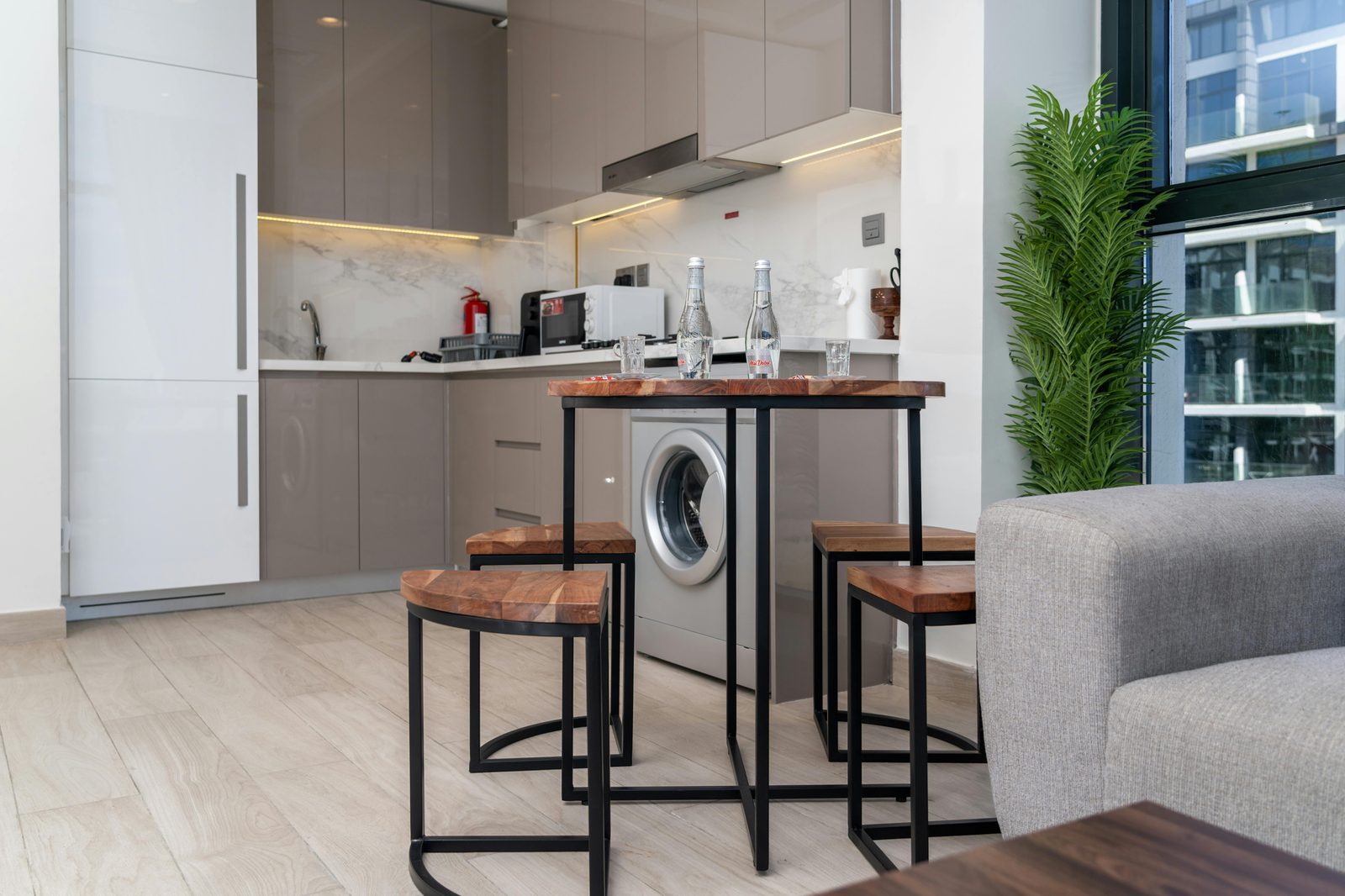 Modern small apartment kitchen — Copenhagen Airbnb apartments include full kitchens with quality cookware, saving 200+ DKK per day on restaurant meals
