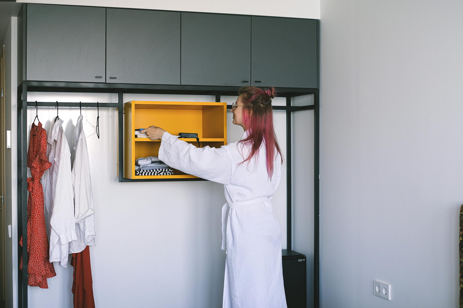 Small modern tidy hotel room — Copenhagen budget hotels feature efficient micro-rooms with smart vertical-storage design