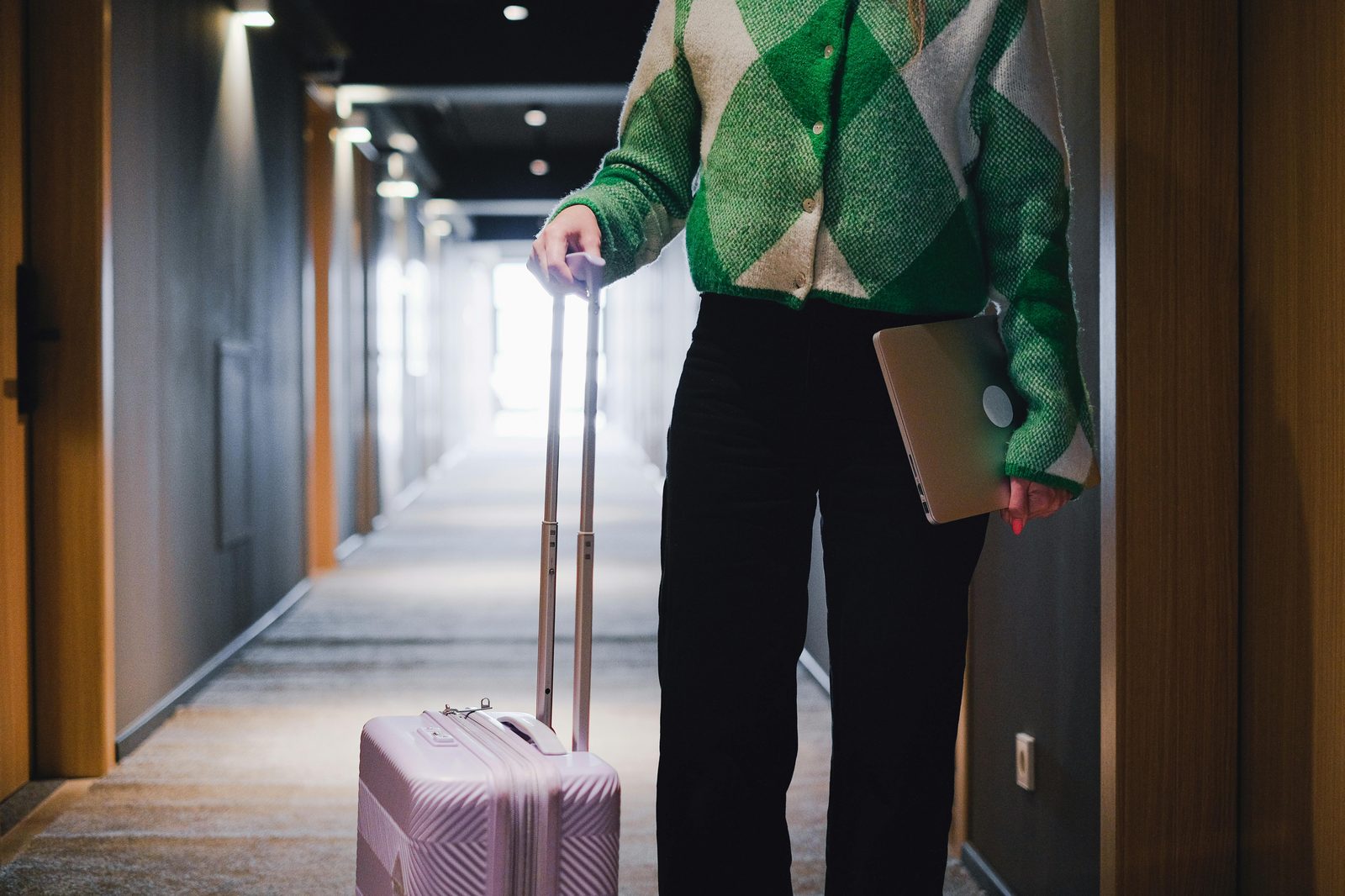 Traveler with suitcase in hotel hallway — Copenhagen budget hotels suit solo travellers, students and short-stay business visitors