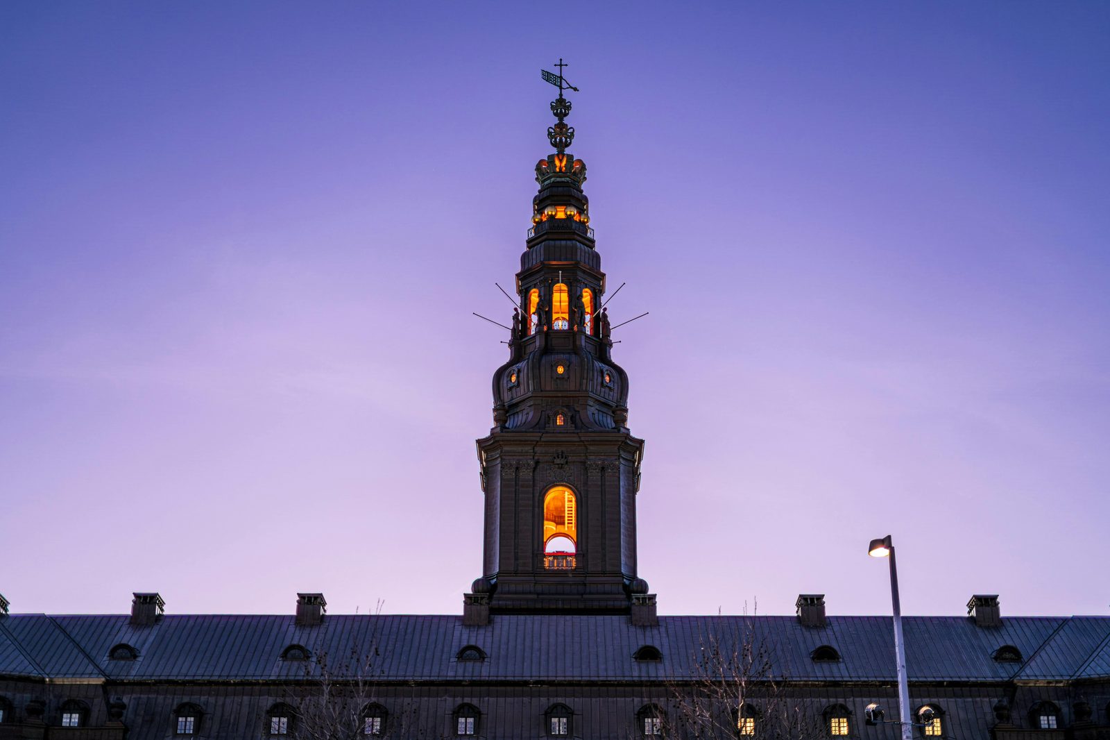 Christiansborg Palace illuminated against a twilight sky — the palace lit up at night is a Copenhagen photography signature