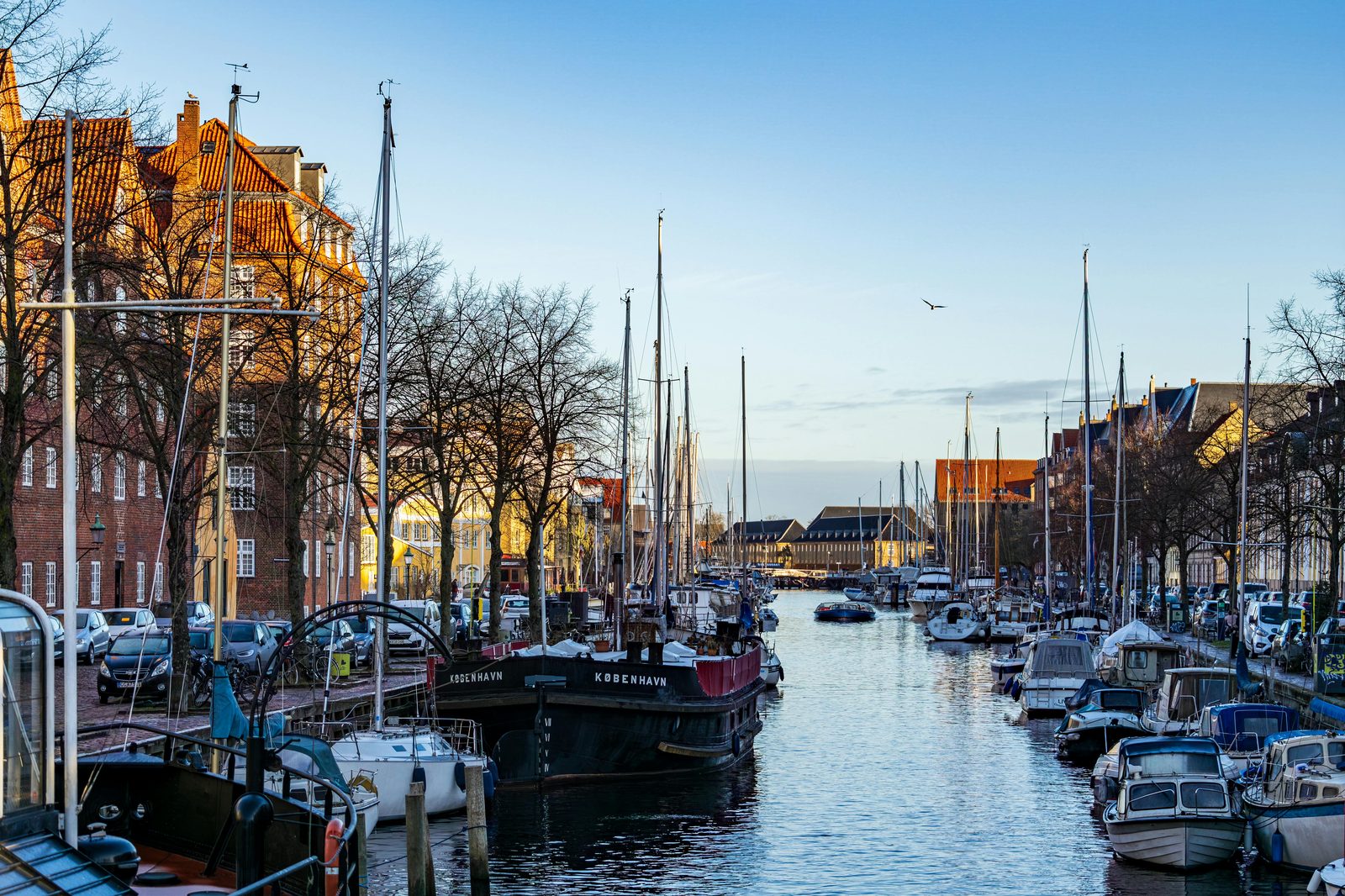 Colorful Christianshavn canal with moored boats and historic Copenhagen buildings