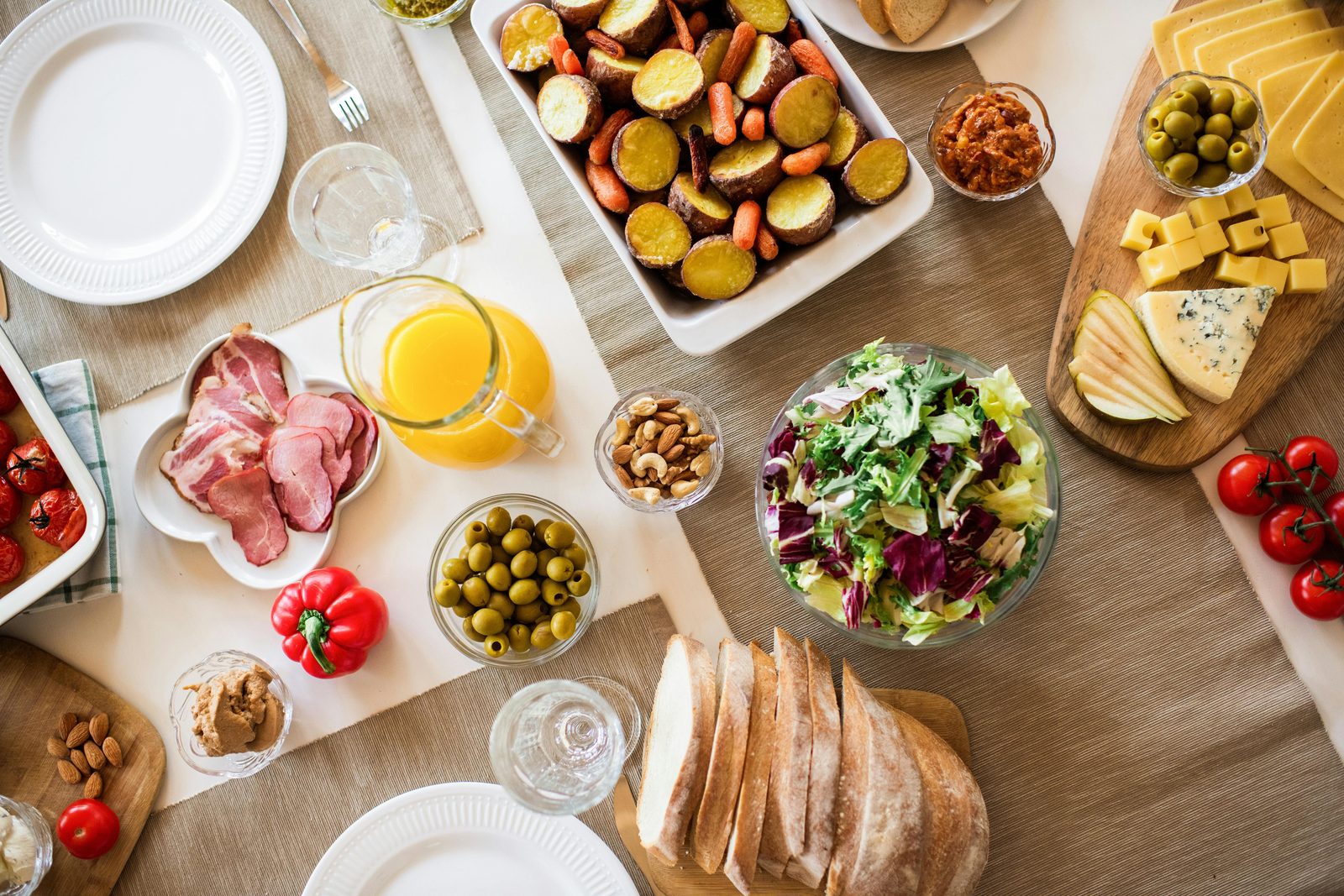 Vibrant brunch table with assorted Scandinavian-style dishes, fresh bread and fruit — typical Copenhagen weekend brunch