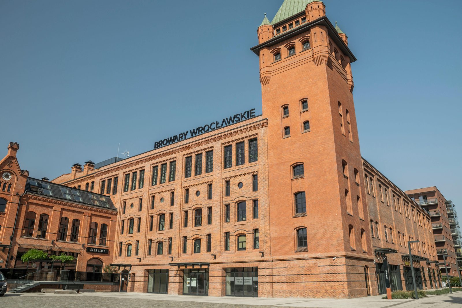 Historic red-brick brewery building — similar to the Carlsberg Byen district in Copenhagen