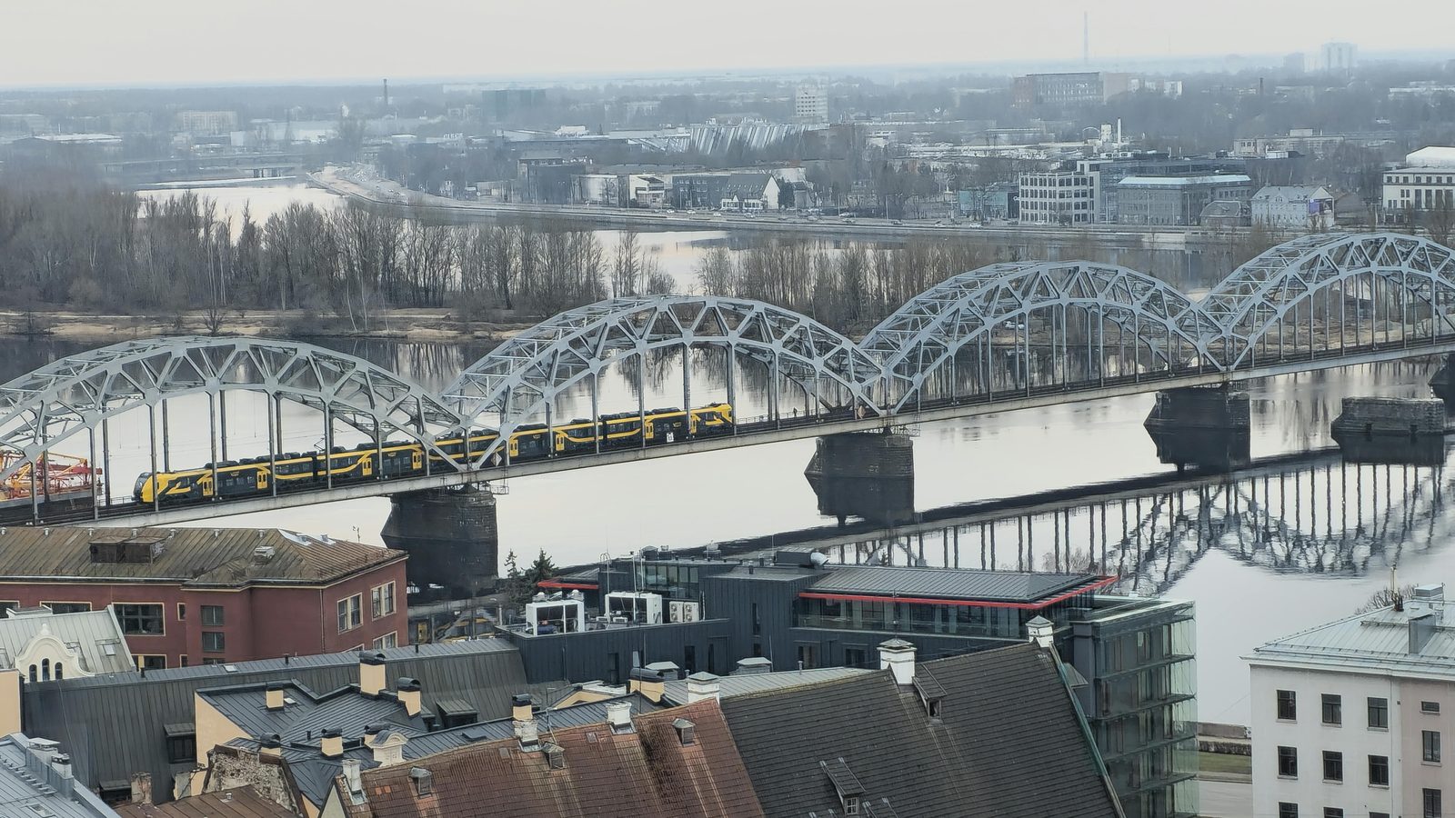 Aerial view of a train crossing a bridge over water — similar to the Øresund Bridge between Copenhagen and Malmö, Sweden