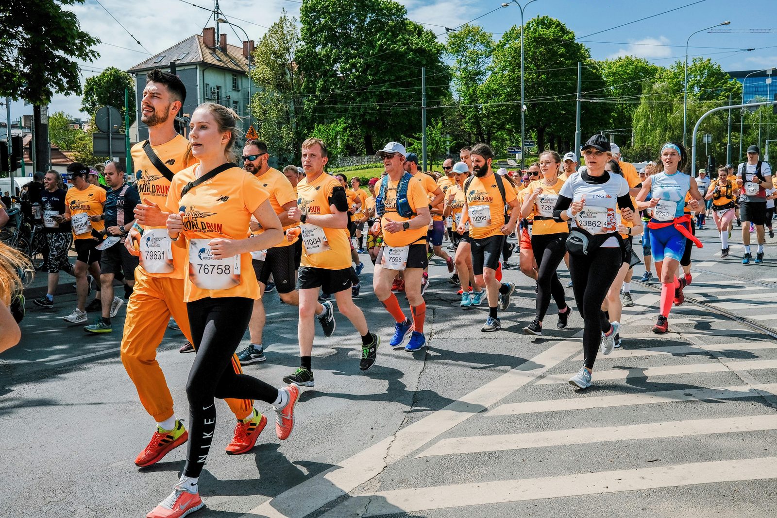 Runners competing in a sunny urban marathon — the Copenhagen Marathon fills the streets with 14,000 runners every May and often sells out in advance