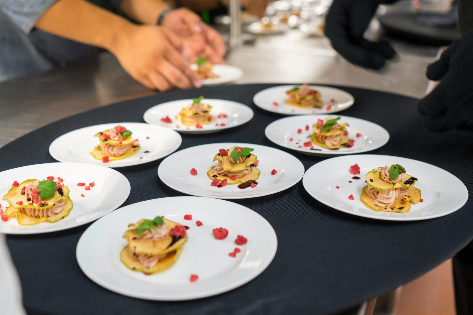 Chef's creative presentation of gourmet Michelin-style appetizers on elegant plates, shot from above