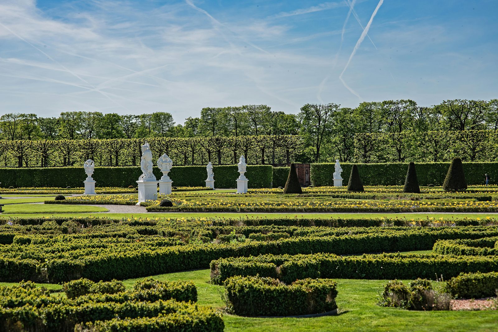 Formal manicured European gardens with sculptures and hedges — similar to Frederiksberg Gardens in Copenhagen