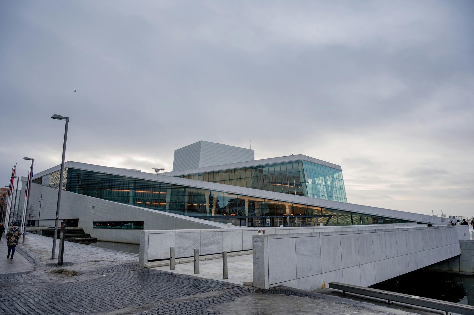 Modern opera house reflected in the water — Copenhagen's own Opera House on Holmen has a similar waterfront presence