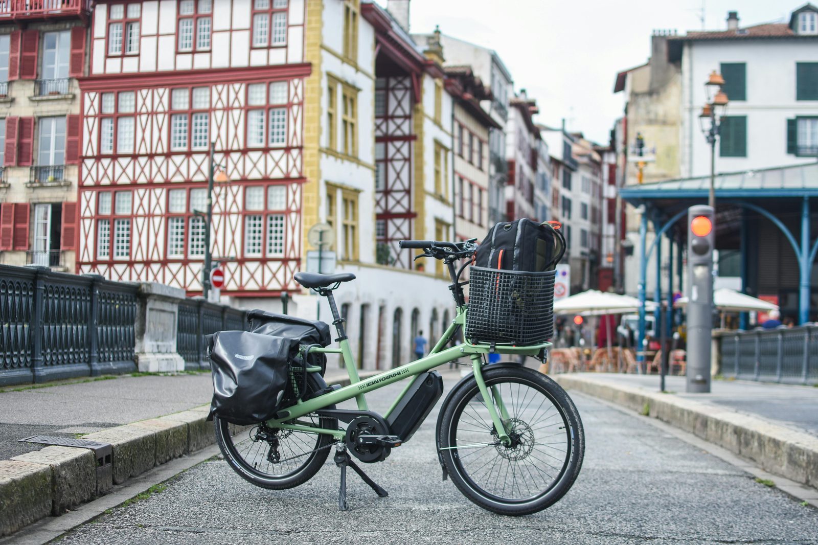 Green cargo bike parked on a European street — similar to the Christiania Bikes and Nihola cargo bikes used by 30% of Copenhagen families