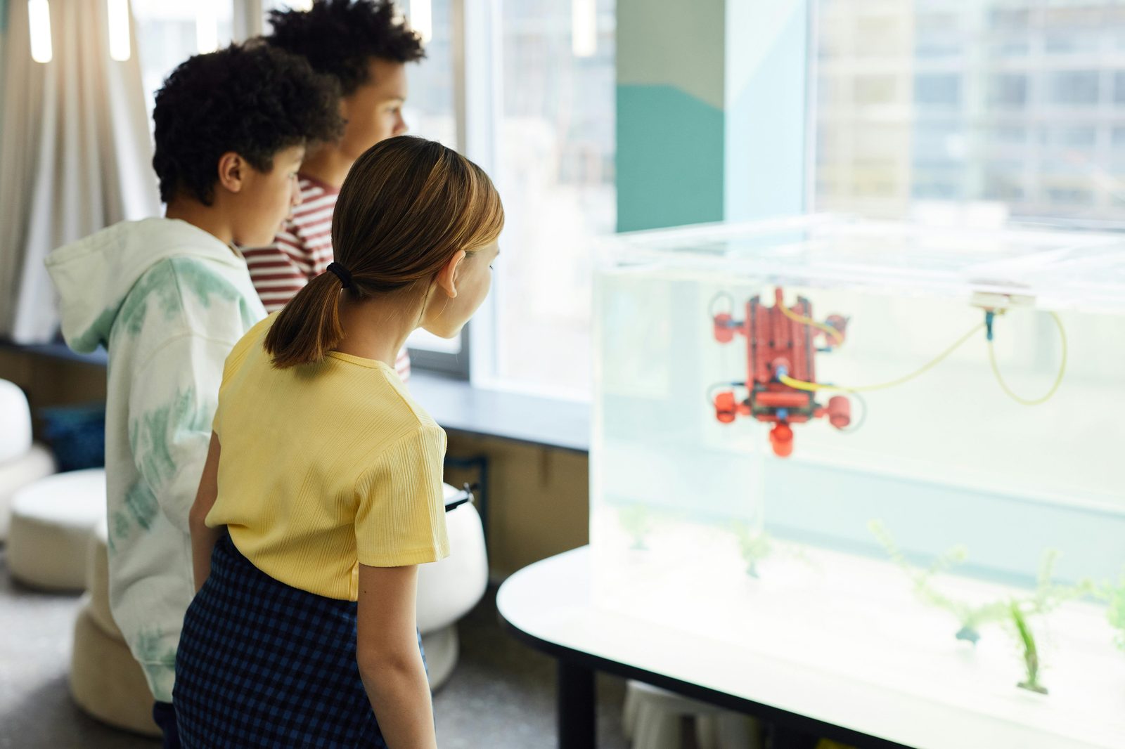 Multiracial children exploring a hands-on educational exhibit — similar to Copenhagen's Experimentarium science centre and the National Museum's children's section