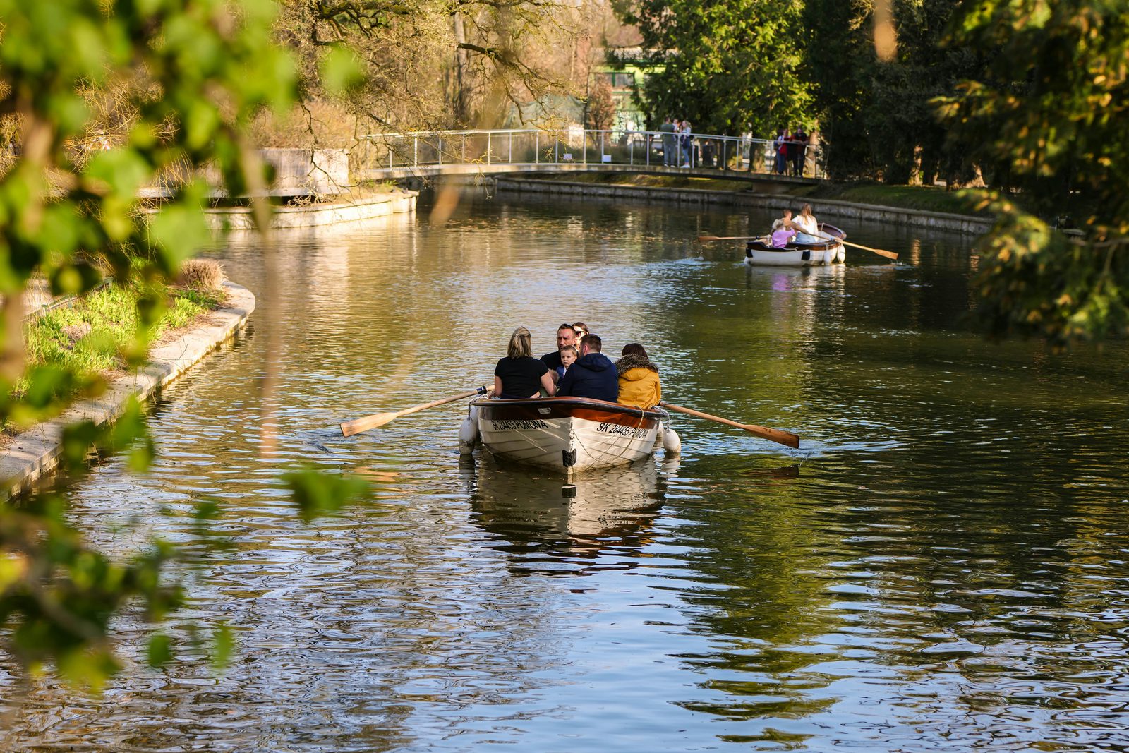 Families enjoying a relaxing day on a calm canal in rowing boats — similar to Nyhavn and the Copenhagen harbour boat tours kids love