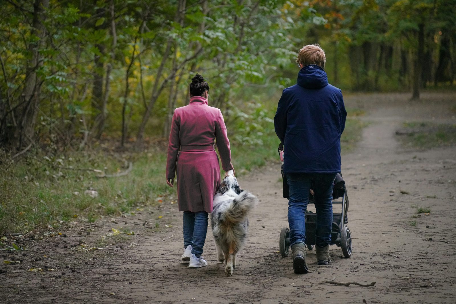 Parents walking with a stroller in a parklike setting — Copenhagen's streets, metro and museums are built to be stroller-accessible