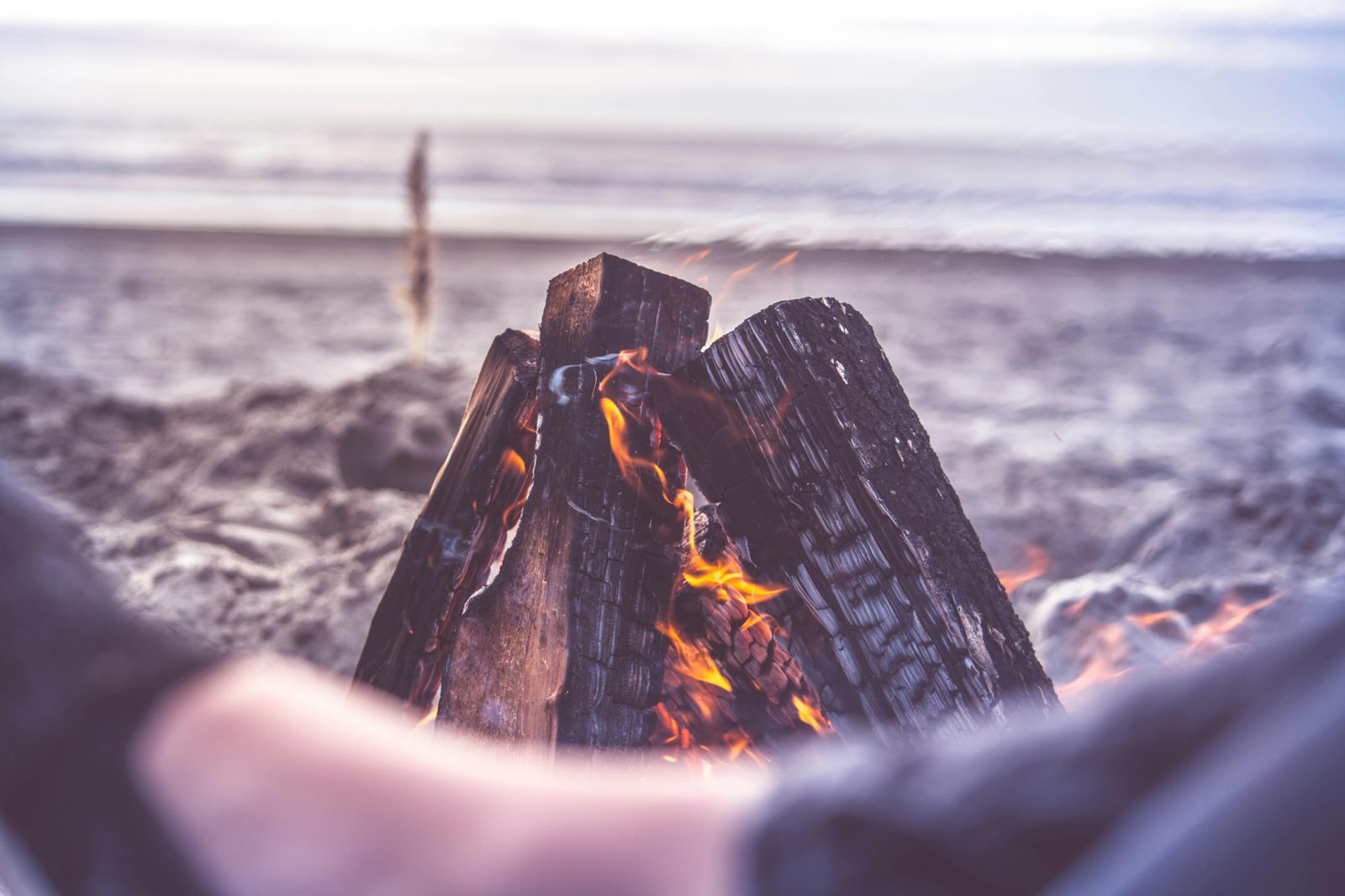 Bonfire on a beach at sunset — similar to Copenhagen's Sankt Hans Aften bonfires at Amager Strand on June 23