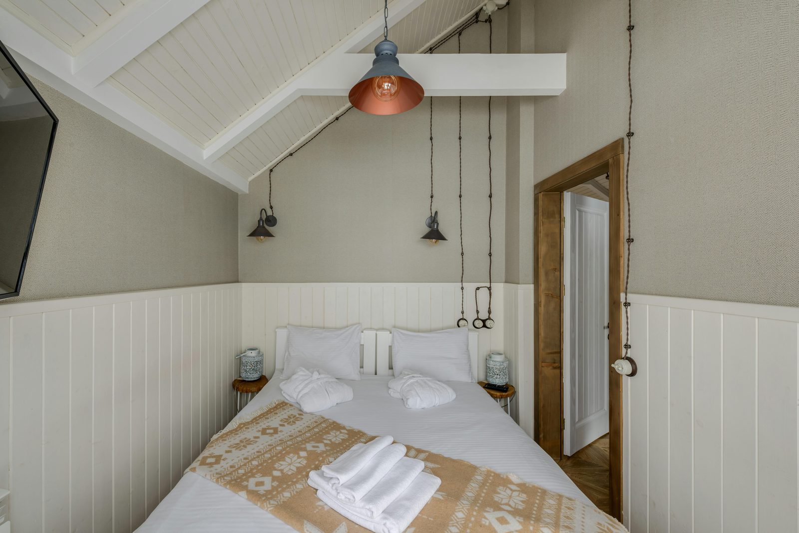 Minimalist Scandinavian hotel bedroom with neutral tones and natural light, typical of Copenhagen design hotels