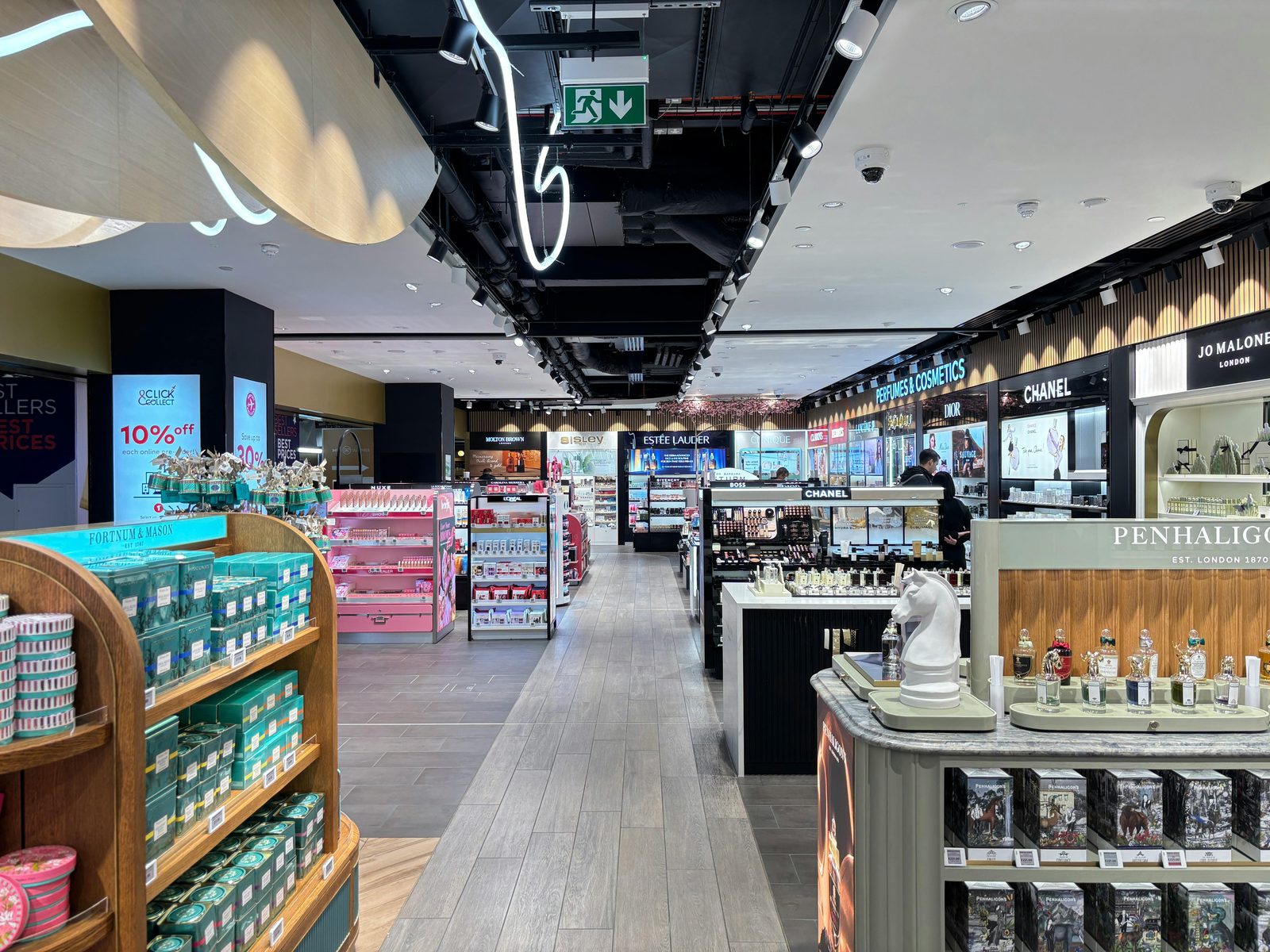 Bright cosmetics store interior showcasing luxury brands — Copenhagen Airport's Terminal 2 and 3 are where you claim your VAT refund and grab last-minute Danish design