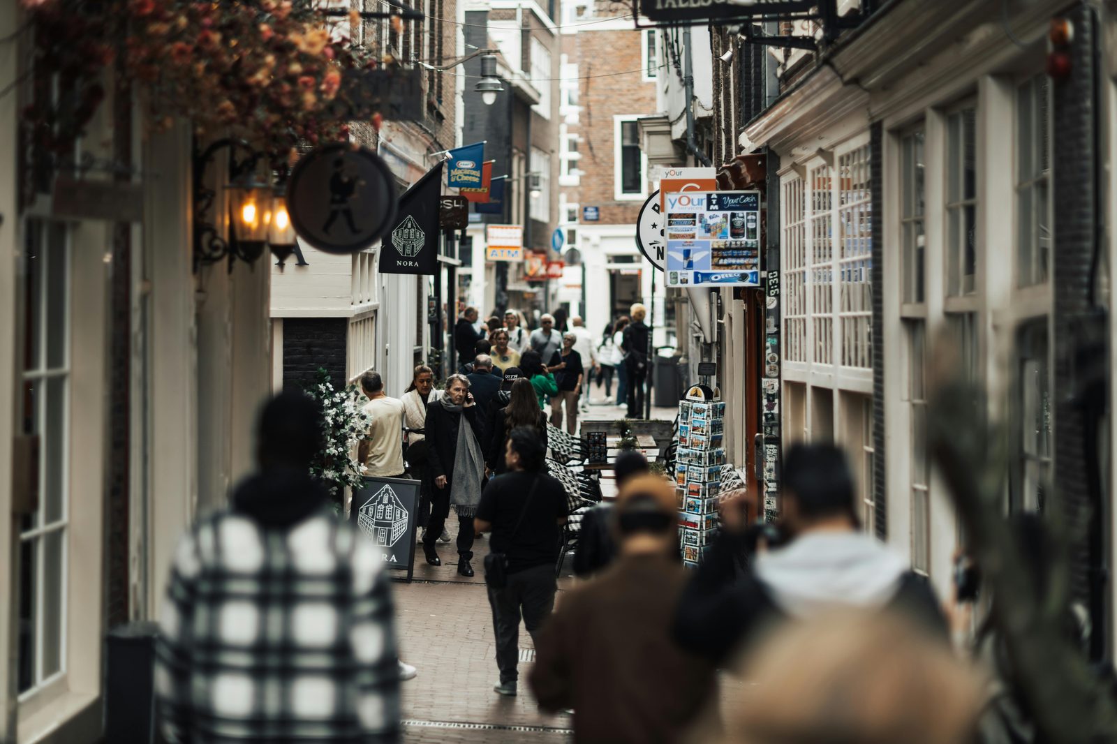 People walking through a narrow European shopping alley — Copenhagen's Strøget is one of Europe's longest pedestrian streets and the backbone of the Copenhagen shopping scene