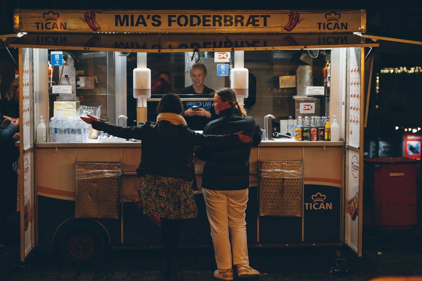 Copenhagen street food market with food trucks and outdoor seating by the harbor