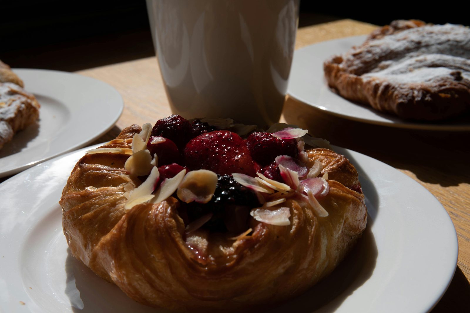 A fresh Danish pastry with berries and almonds — the cheapest breakfast in Copenhagen is a bakery pastry and coffee at 40–60 DKK