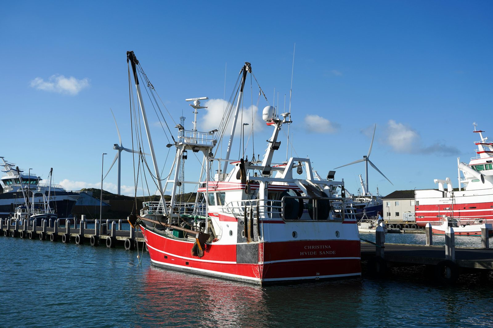Fishing boats moored at a sunny Danish harbour — similar to Dragør, the preserved 18th-century fishing village on Copenhagen's southern edge