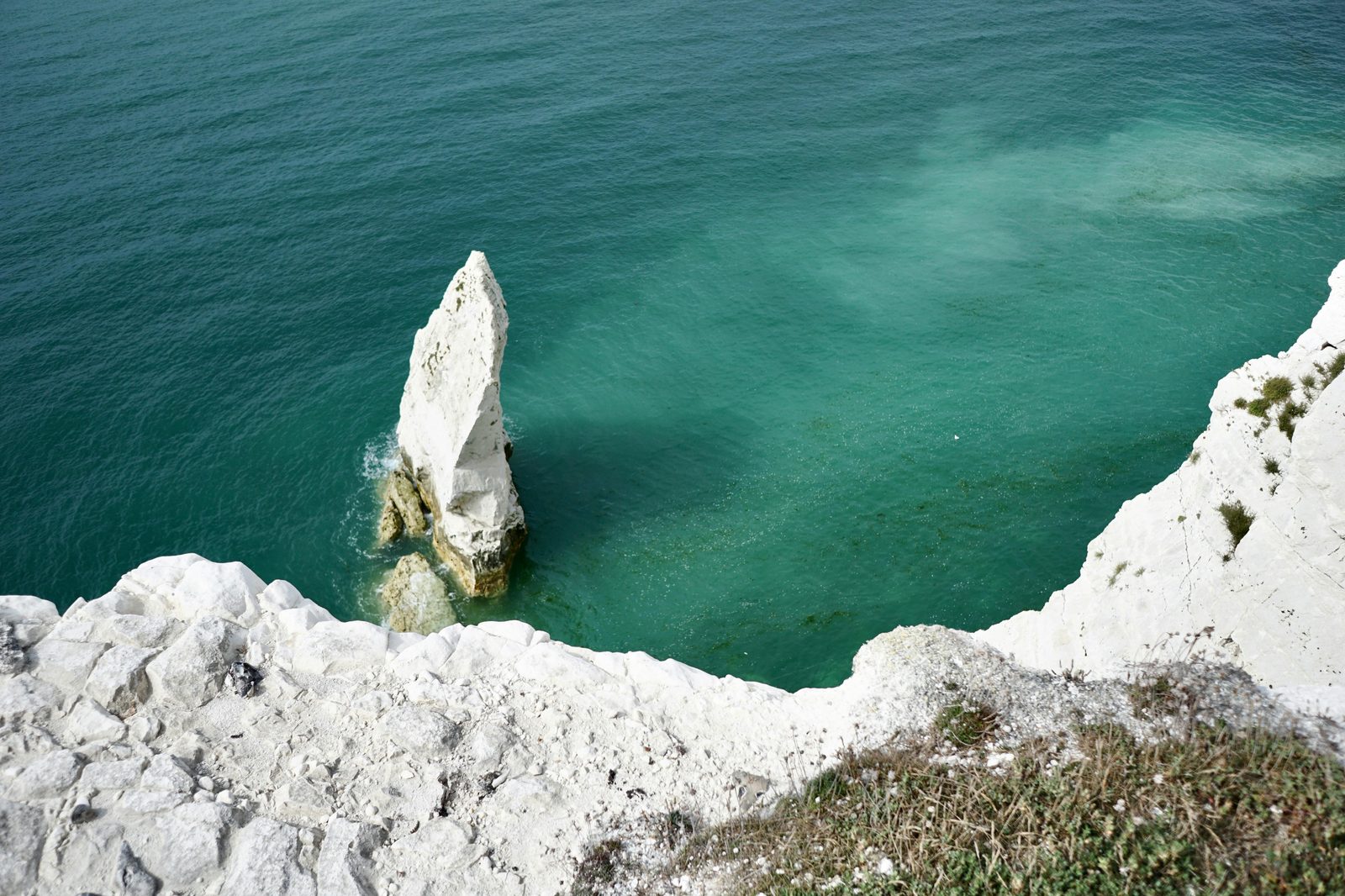White chalk cliffs meeting vibrant turquoise sea — similar to Møns Klint, Denmark's 120-metre-high white cliffs, a 1.5-hour drive south of Copenhagen