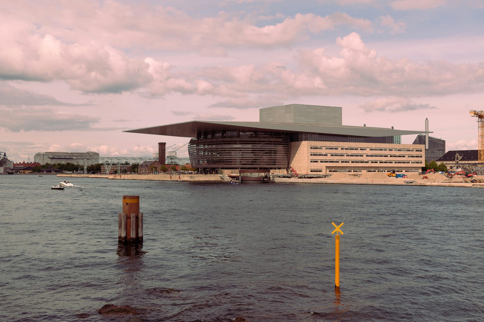Stunning view of the Neo-Futuristic Copenhagen Opera House — the harbour view from the Little Mermaid statue includes the Opera House, Royal Library and the new Cruise Terminal