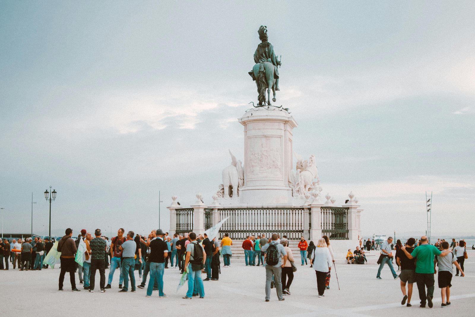 Tourists gathering around an iconic statue on a sunny day — the Little Mermaid statue draws over a million visitors annually, mostly in summer mornings