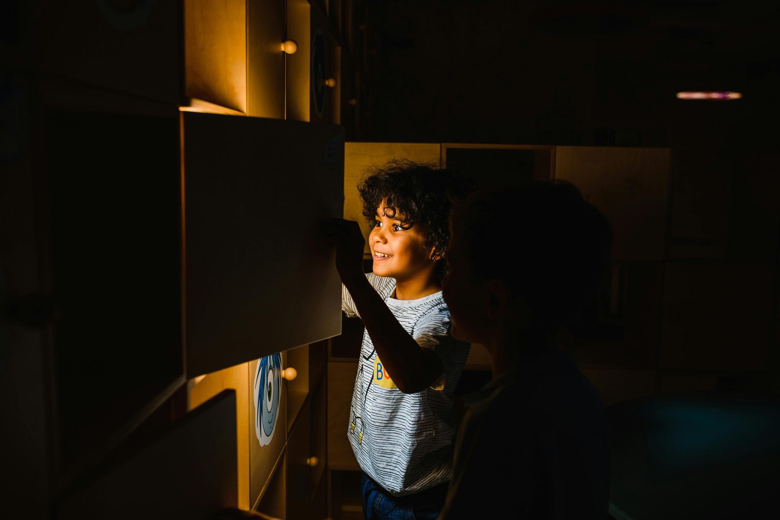 Two boys engage with a glowing educational display, highlighting curiosity and learning — the National Museum's Children's Museum on the second floor is one of Copenhagen's best free family attractions