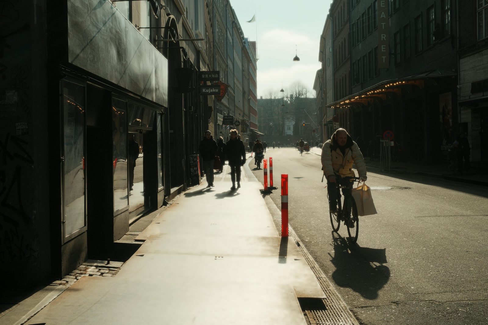 Busy Copenhagen street with cyclists and pedestrians, typical of Nørrebro's daily life