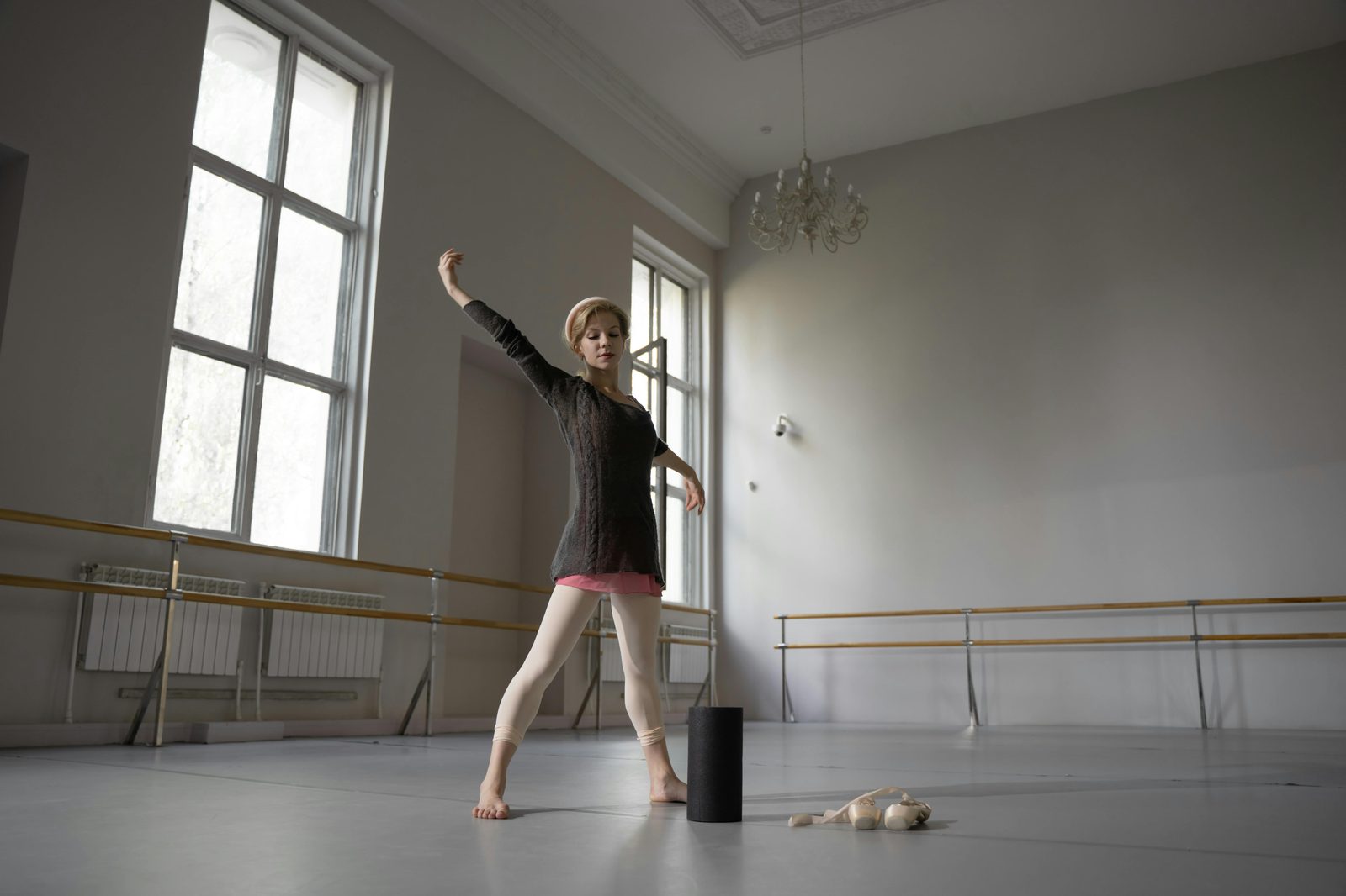Ballet dancer practicing in a sunlit studio — the Glyptotek owns 'The Little Dancer Aged Fourteen', one of Edgar Degas's most famous bronzes