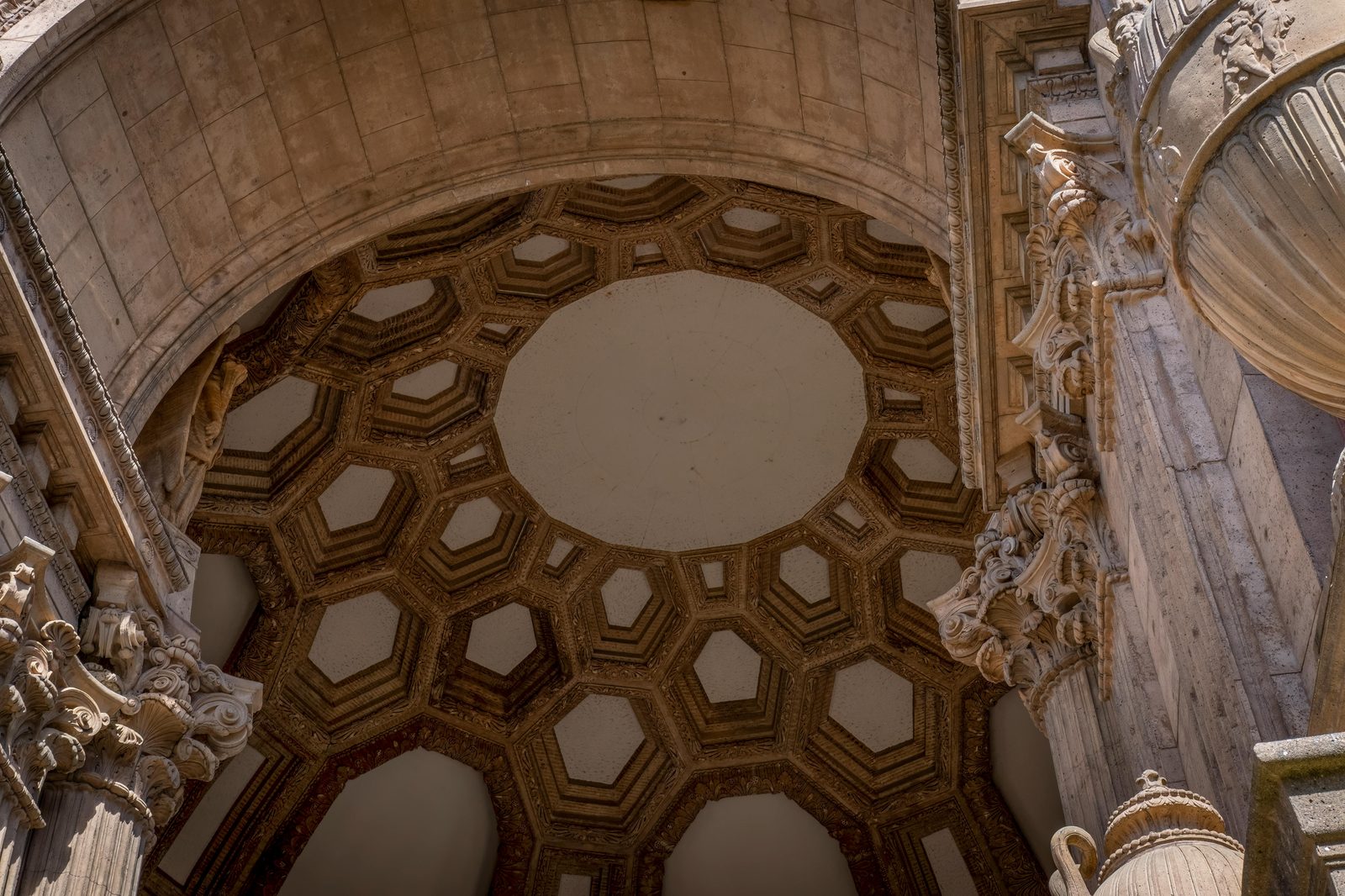 Low-angle view of an ornate dome with stone columns showcasing detailed architecture — the Glyptotek's central dome is the museum's neoclassical signature