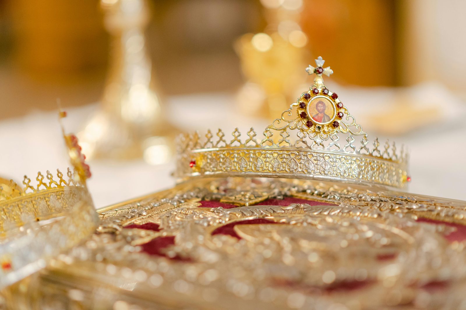 Close-up of a luxurious gold crown adorned with intricate designs and jewels — Denmark's Crown Jewels are kept in Rosenborg's basement Treasury