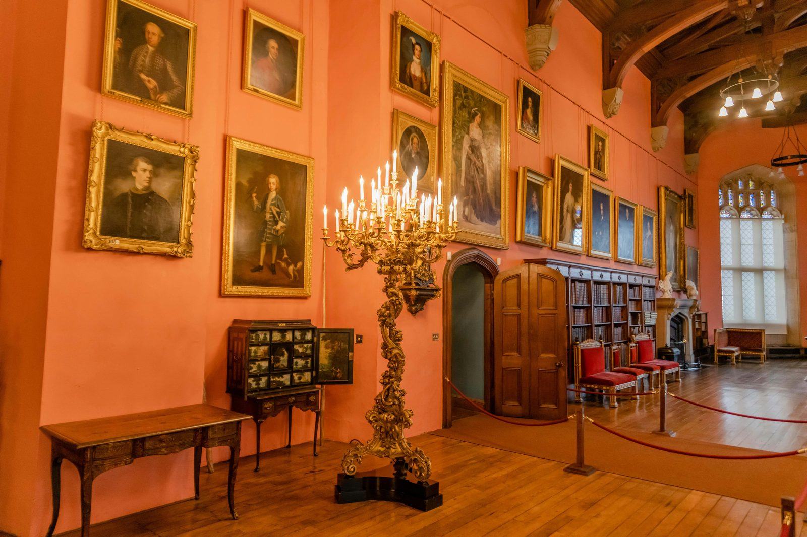 Elegant interior of a long castle hall showcasing antique furniture and classic paintings — Rosenborg's Long Hall is the Knights' Hall with three silver lions guarding the throne