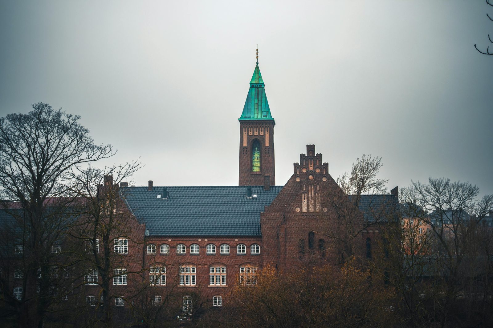 Majestic historical building in Copenhagen with autumn trees and a cloudy sky — Rundetaarn (the Round Tower) was completed in 1642 by Christian IV as Europe's oldest still-functioning observatory