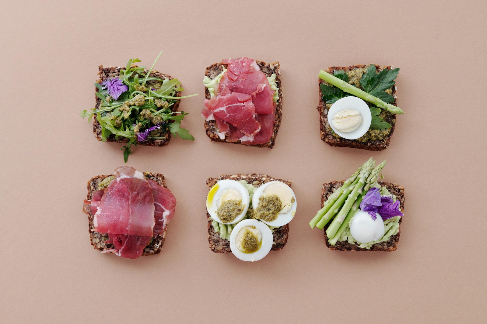 Traditional Danish smørrebrød open-faced sandwiches with fresh ingredients — a must-try food in Copenhagen