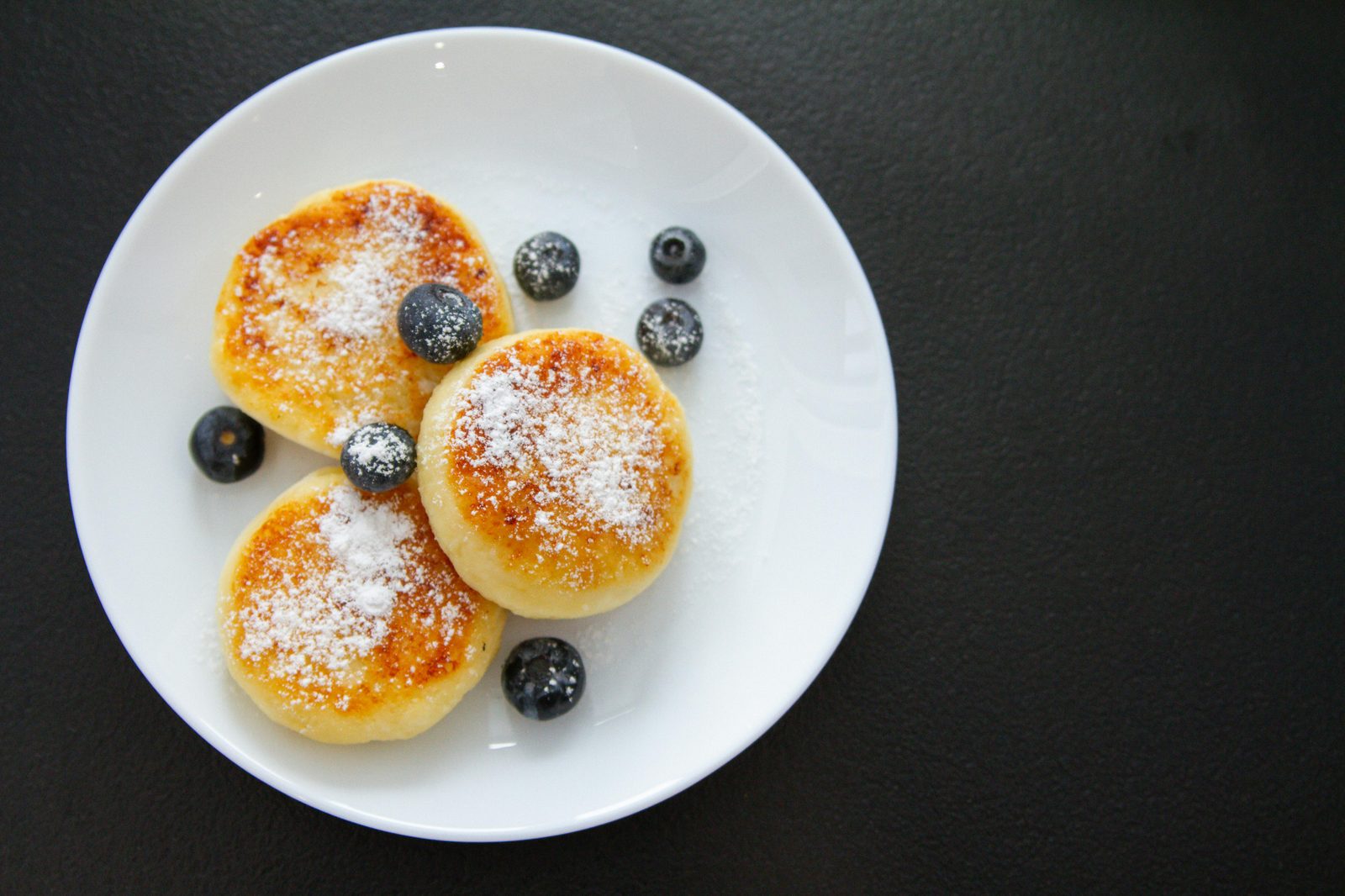 Danish æbleskiver, round pancakes dusted with sugar, at a Copenhagen Christmas market