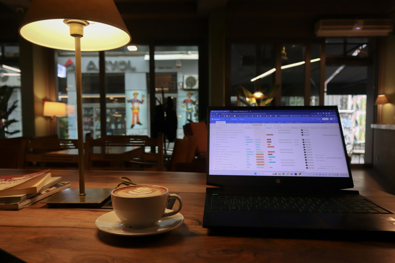 Laptop on cafe table with coffee — many Copenhagen specialty cafes are work-friendly, popular with digital nomads and remote workers