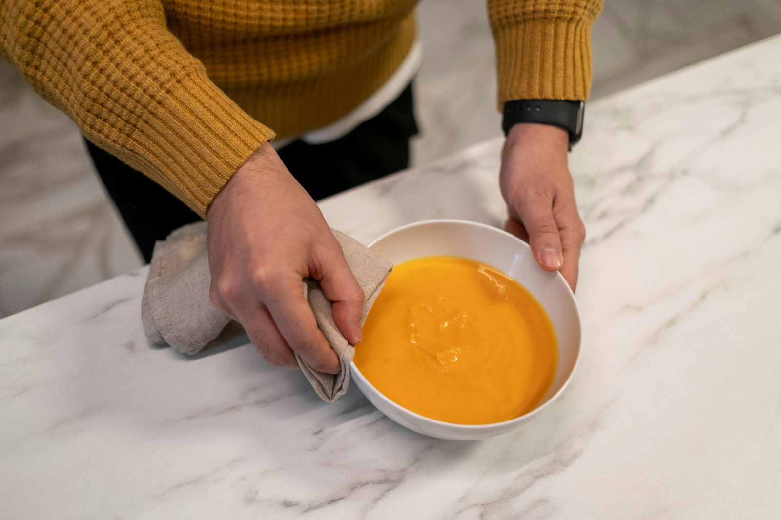 Warm bowl soup hands cozy — Copenhagen autumn comfort food includes hearty Nordic soups, smorrebrod, and frikadeller meatballs