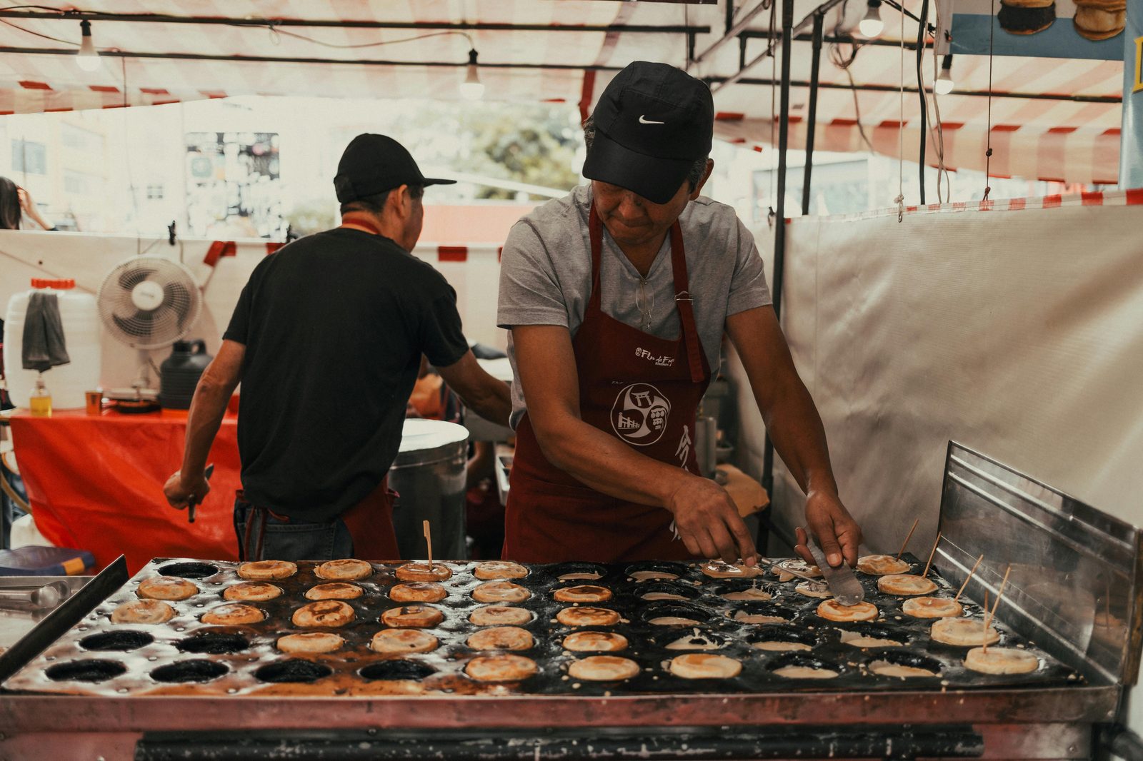 Food vendor at outdoor stall — Reffen has 50+ vendors covering every world cuisine