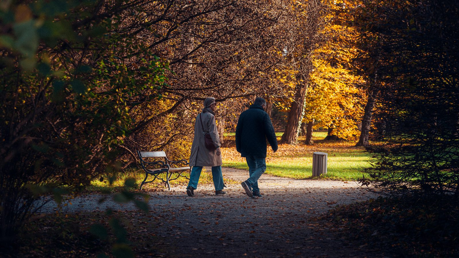 A couple walking through an autumn park — a quiet side of Copenhagen for couples