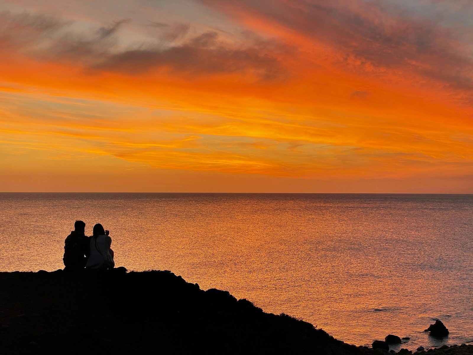 A couple watching the sunset — the best romantic sunset for Copenhagen for couples