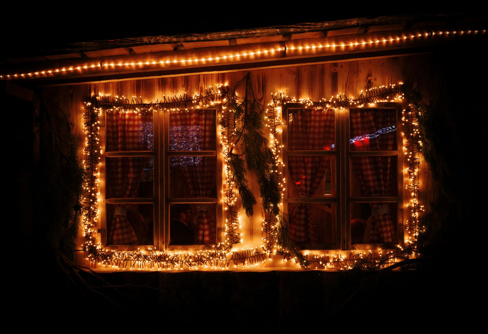 Warm window light winter evening — Copenhagen December evenings feature warm cafe windows, candle-lit homes, and abundant Christmas illumination