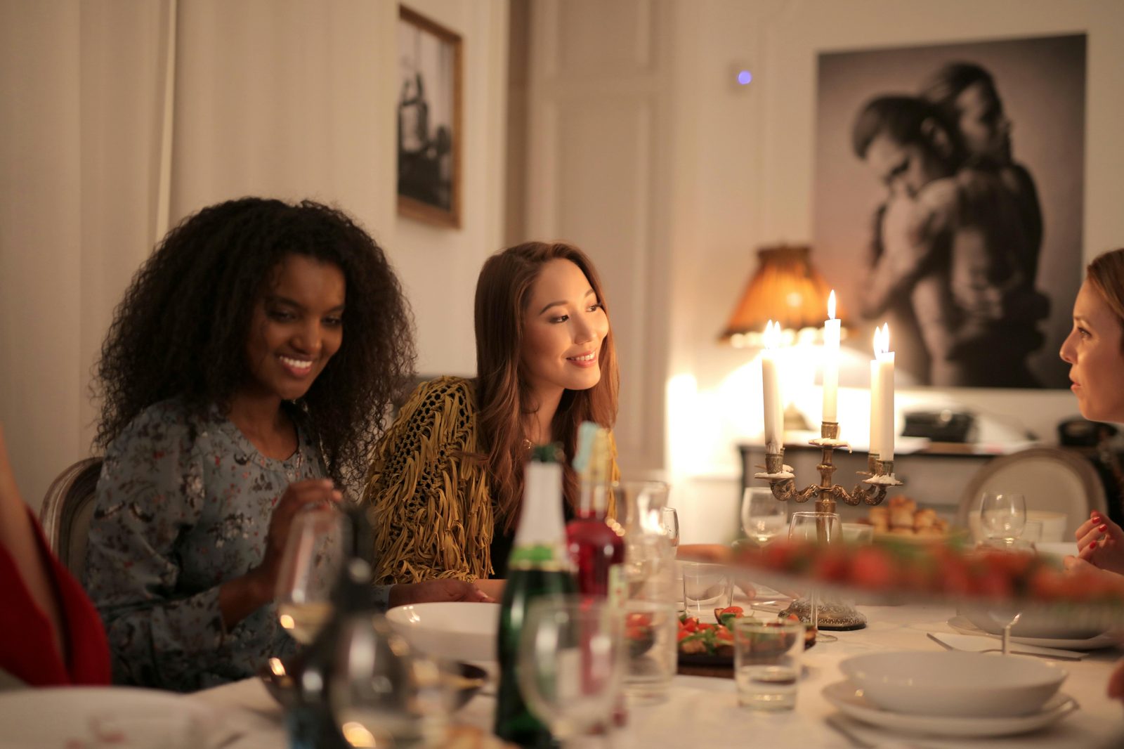 Friends candle dinner cozy — Danish hygge social gatherings feature small groups, candle-lit tables, slow meals, no rushing