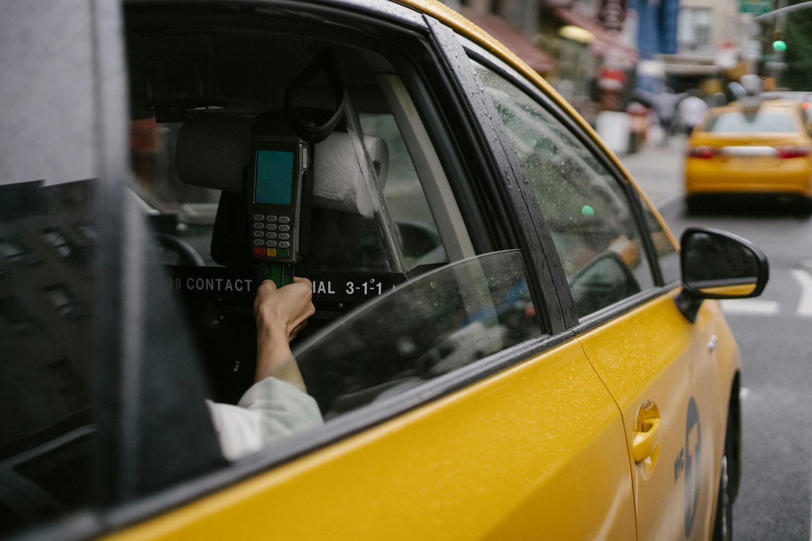 A card in a payment terminal inside a Copenhagen taxi — Visa, Mastercard and Apple Pay are all accepted