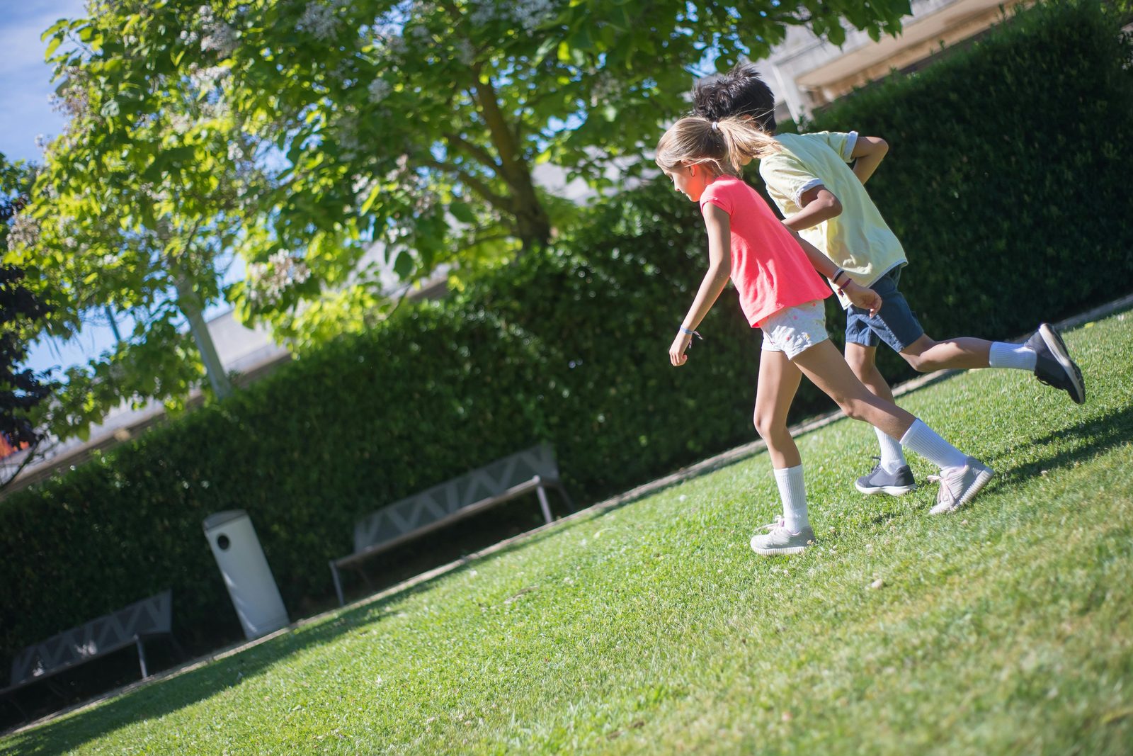 Children running through a linear park in Vesterbro, Copenhagen