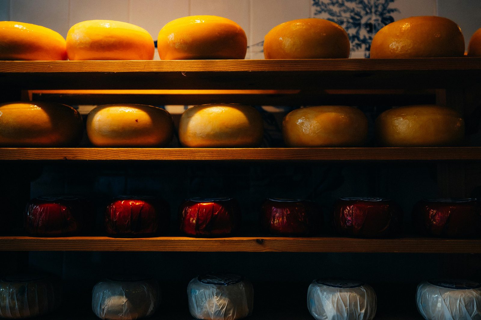 Cheese counter at specialty market — Torvehallerne hosts multiple cheese specialists including Arla, Unika, and Osteriet sourcing from small Danish dairies