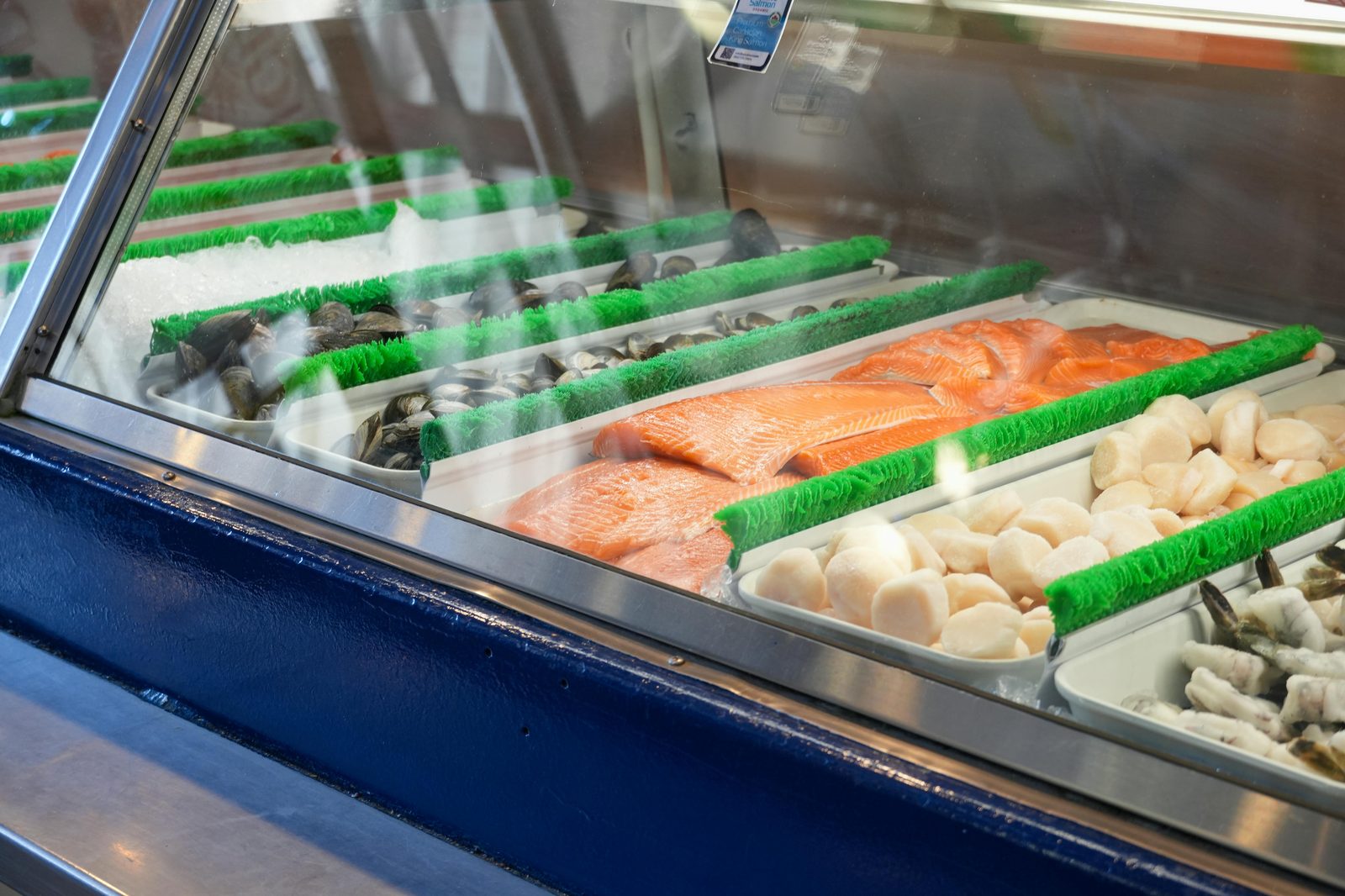 Fish market with fresh seafood counter — Torvehallerne's fishmongers sell whole fish, smoked salmon, oysters, and Danish seafood specialties