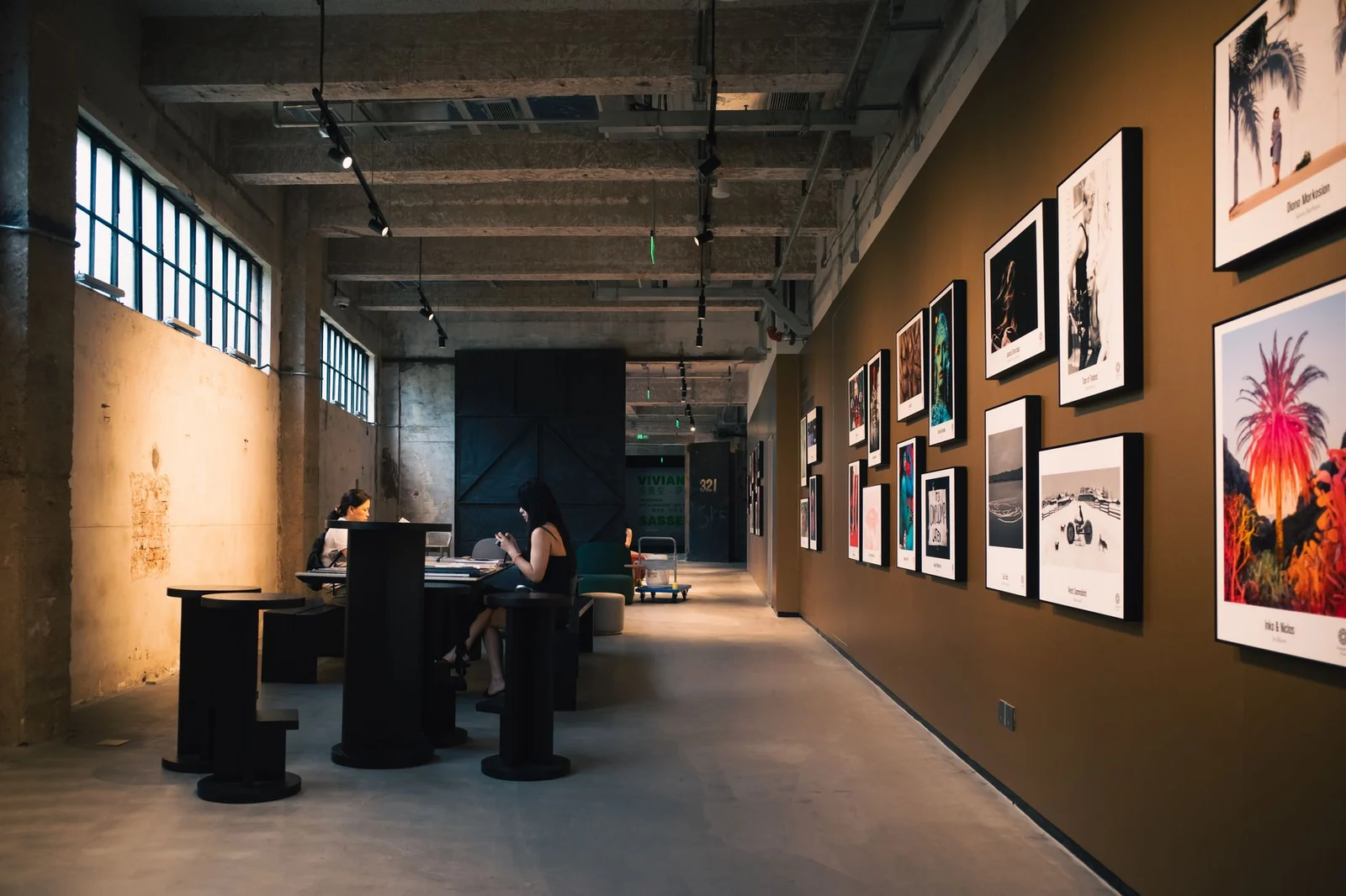 Visitors in a gallery hung with framed works, typical of Copenhagen museum interiors