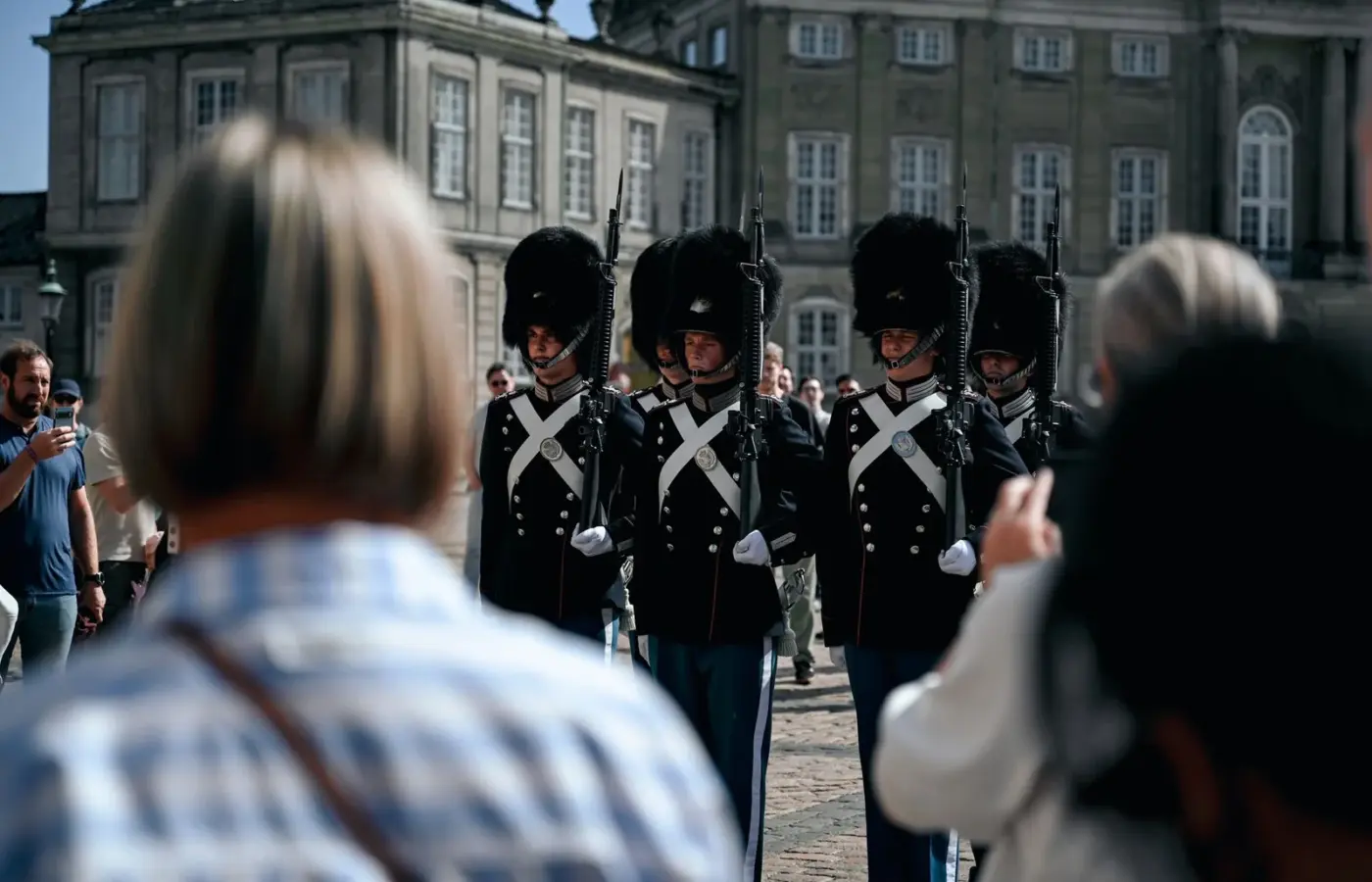 Royal Life Guards in bearskin caps marching past spectators at Amalienborg Palace