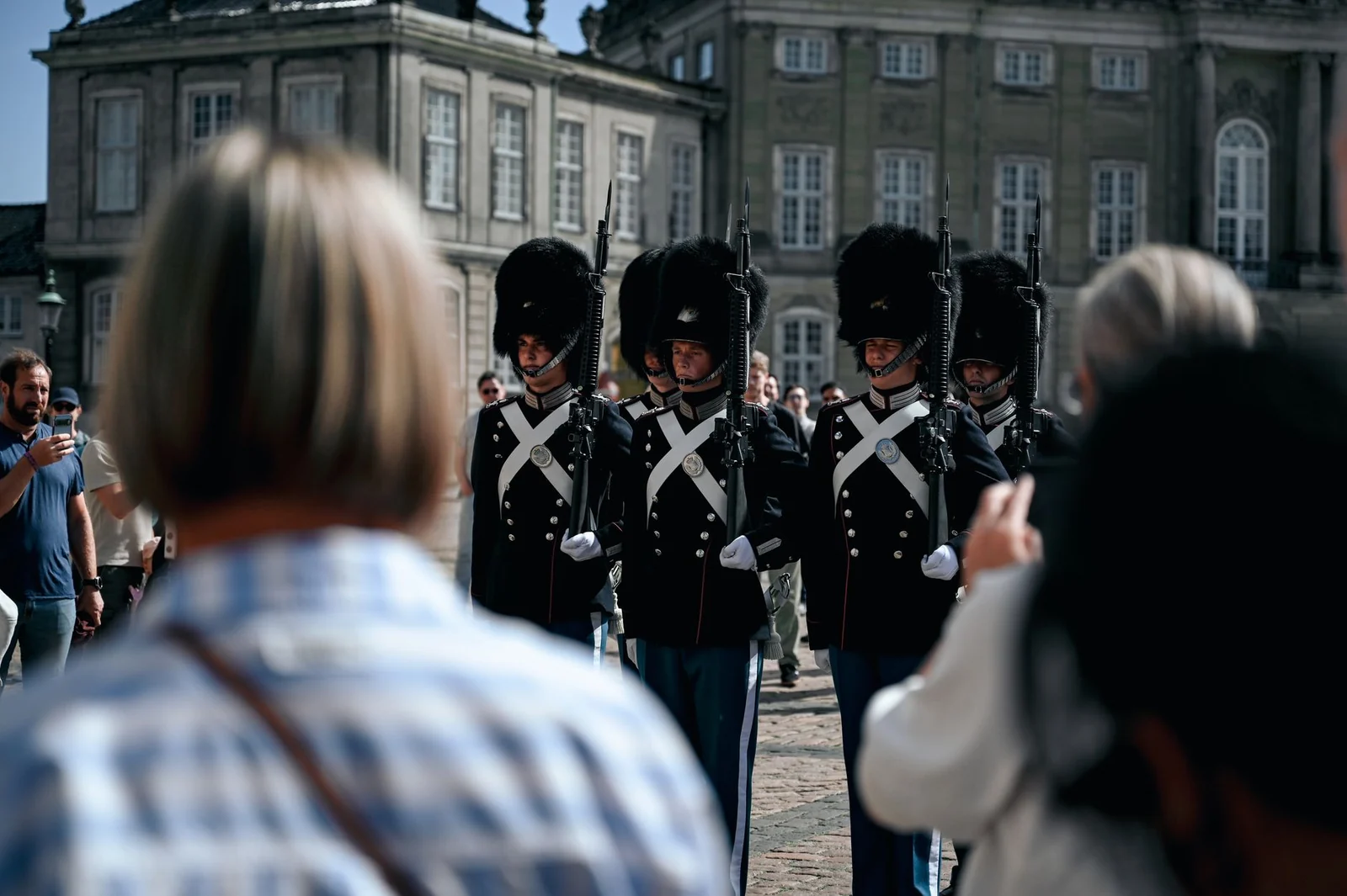 Royal Life Guards in bearskin caps marching past spectators at Amalienborg Palace