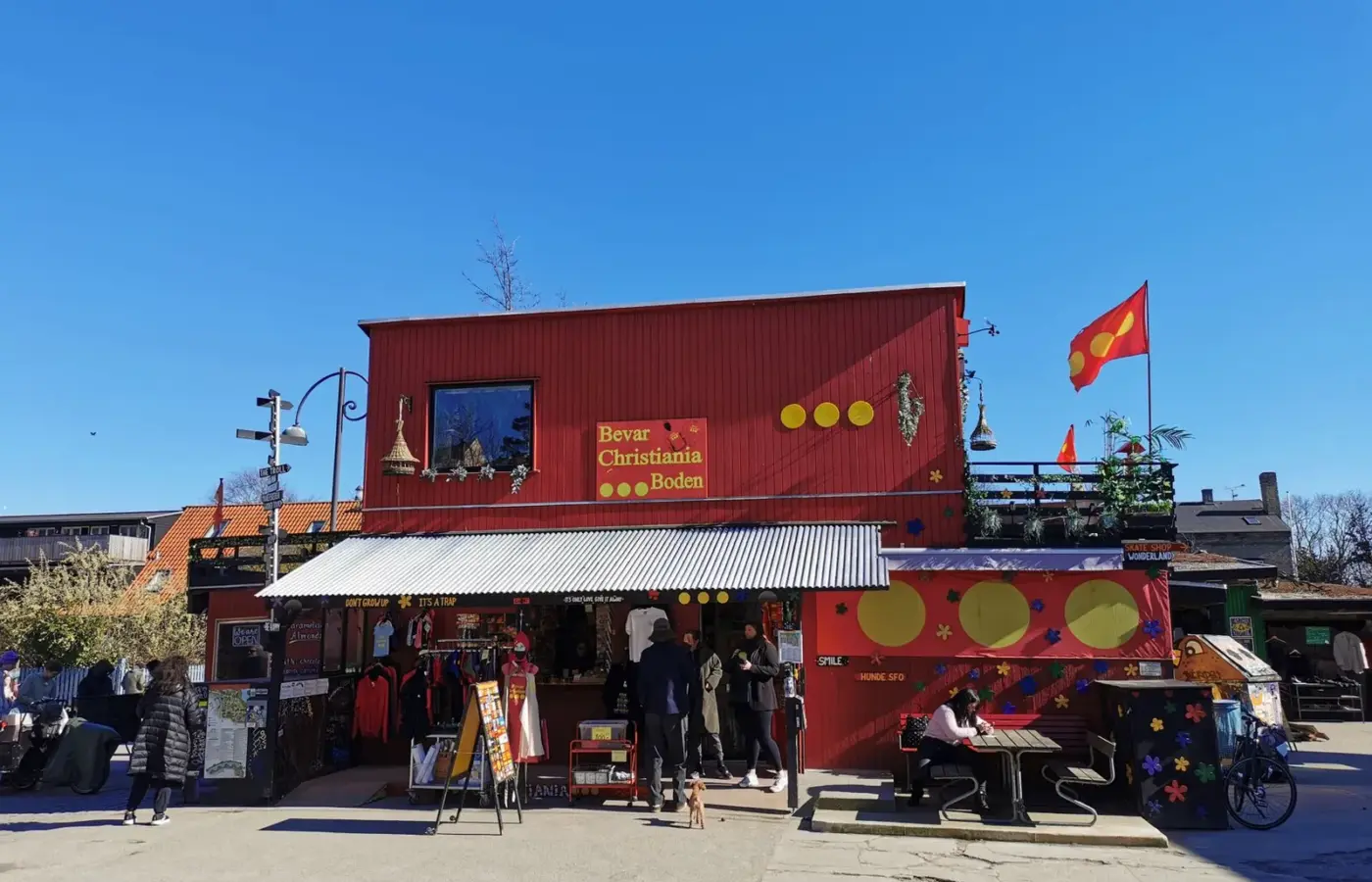 Shops and the Christiania flag flying in Freetown Christiania, Copenhagen